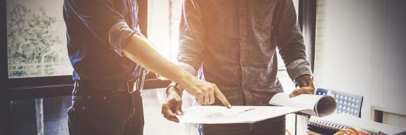 Deux hommes debout devant des plans